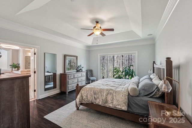 bedroom featuring multiple windows, a raised ceiling, dark wood-type flooring, and crown molding