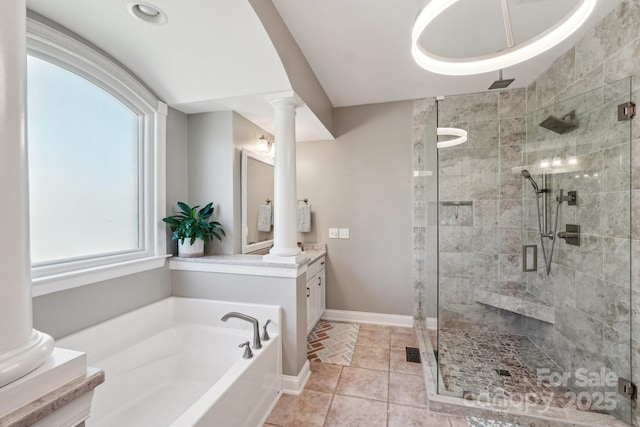 full bath featuring a garden tub, a stall shower, tile patterned flooring, decorative columns, and vanity