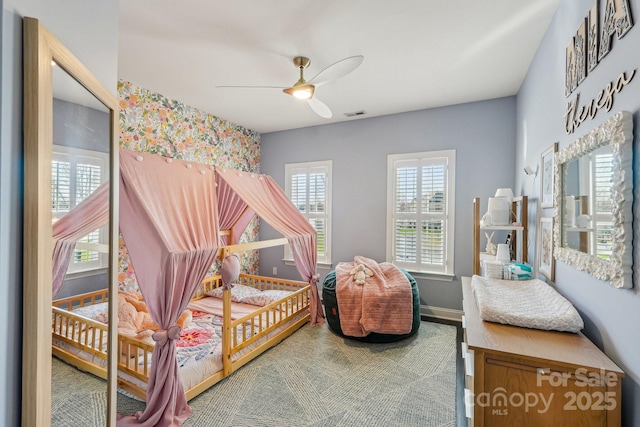 bedroom featuring a ceiling fan, visible vents, and baseboards