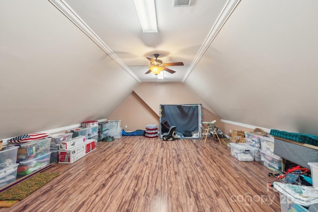 additional living space featuring visible vents, wood finished floors, a ceiling fan, and vaulted ceiling