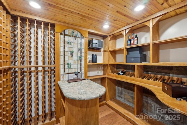 wine room with recessed lighting, wood ceiling, and a wall mounted AC