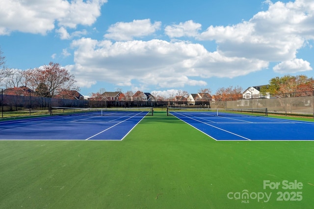 view of tennis court featuring fence