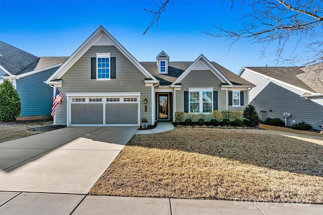 view of front of home with a garage, driveway, and roof with shingles