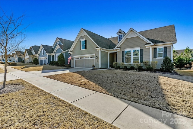 view of front of property featuring a residential view, an attached garage, and concrete driveway