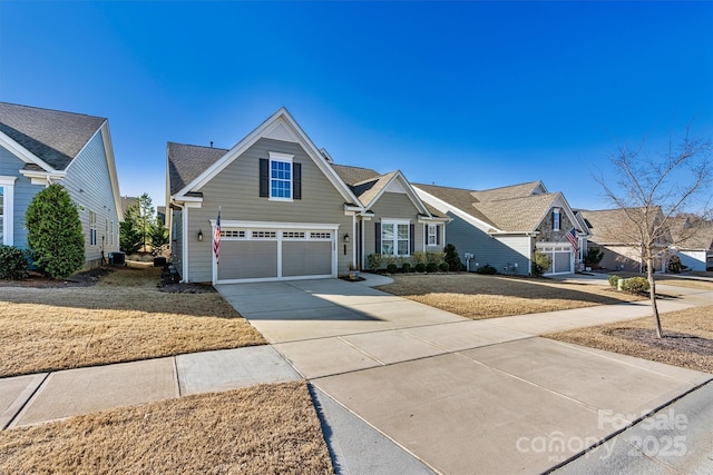 traditional home featuring a garage, cooling unit, and driveway