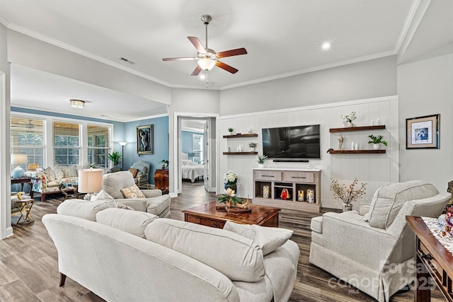 living room featuring visible vents, a healthy amount of sunlight, ceiling fan, and wood finished floors