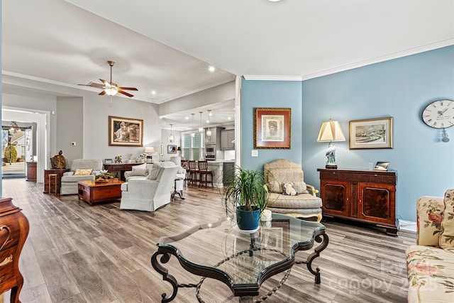 living room featuring crown molding, recessed lighting, wood finished floors, and ceiling fan