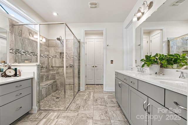 bathroom featuring a sink, visible vents, and a stall shower