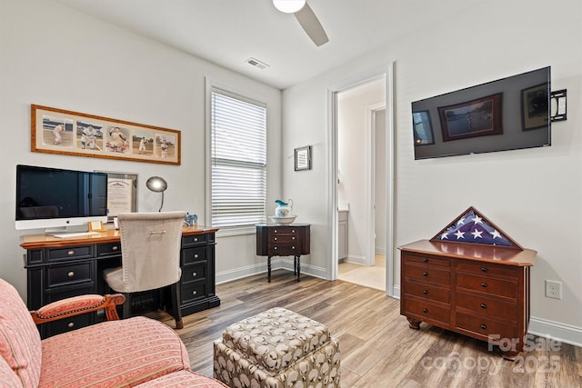 home office with baseboards, light wood-style floors, visible vents, and ceiling fan