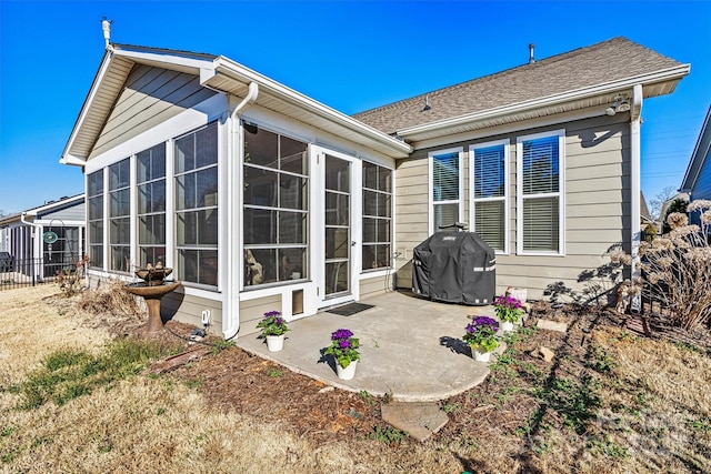 back of house with a patio area, fence, and a sunroom