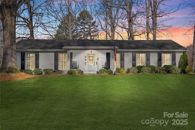 ranch-style house with stucco siding and a front lawn