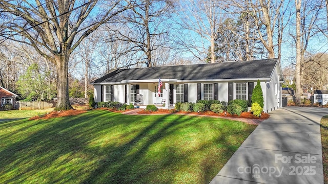 single story home with a front yard, concrete driveway, fence, and stucco siding