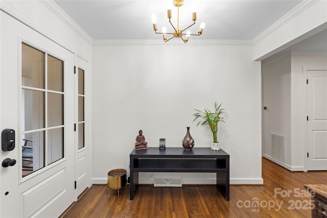 entryway with ornamental molding, visible vents, and a chandelier