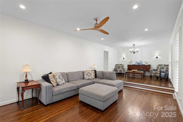 living room featuring recessed lighting, dark wood-style floors, crown molding, and ceiling fan with notable chandelier