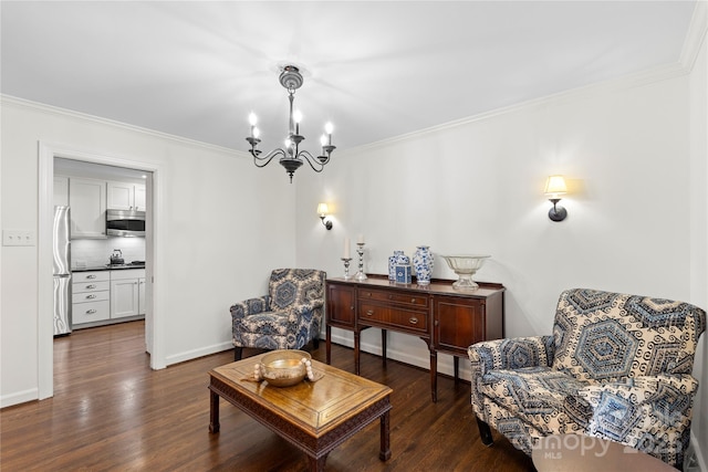 sitting room with dark wood-type flooring, crown molding, baseboards, and a chandelier