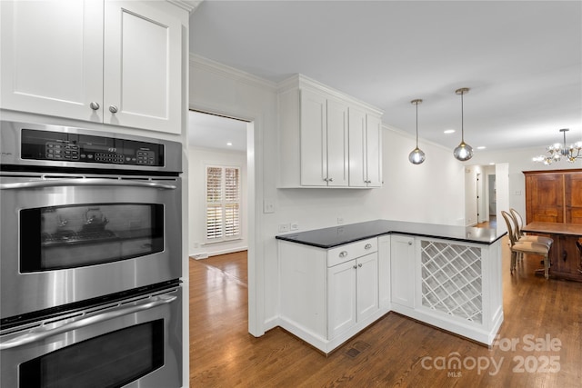 kitchen with stainless steel double oven, a peninsula, white cabinetry, and dark wood-type flooring