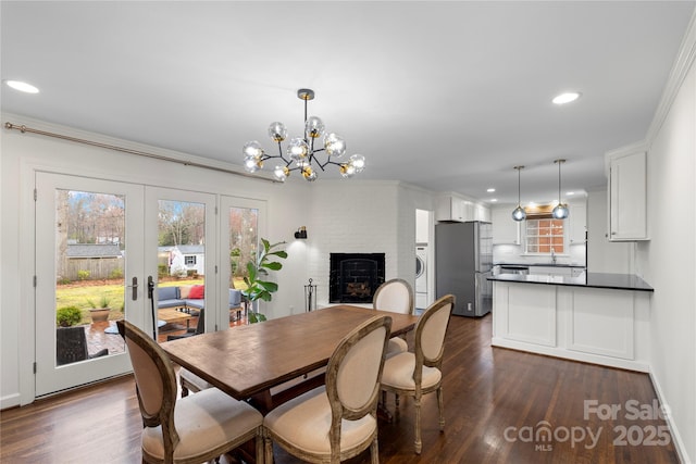 dining room with recessed lighting, a healthy amount of sunlight, and dark wood-style flooring