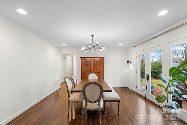 dining room featuring baseboards, dark wood finished floors, ornamental molding, recessed lighting, and a notable chandelier