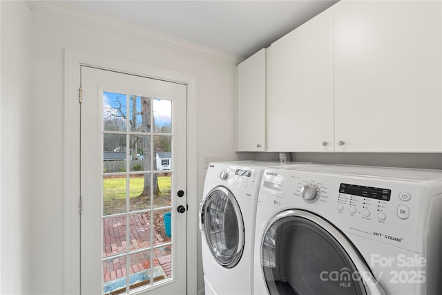 laundry area with separate washer and dryer, cabinet space, and ornamental molding