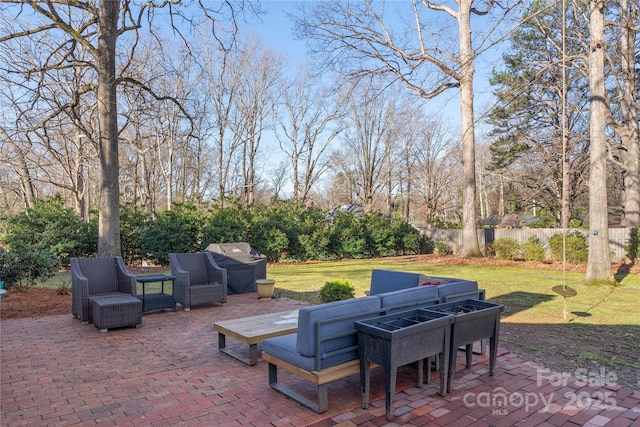 view of patio / terrace featuring a grill and fence