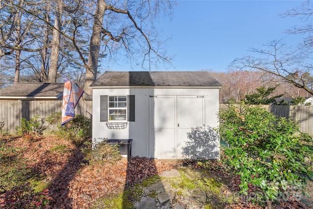 view of shed with fence