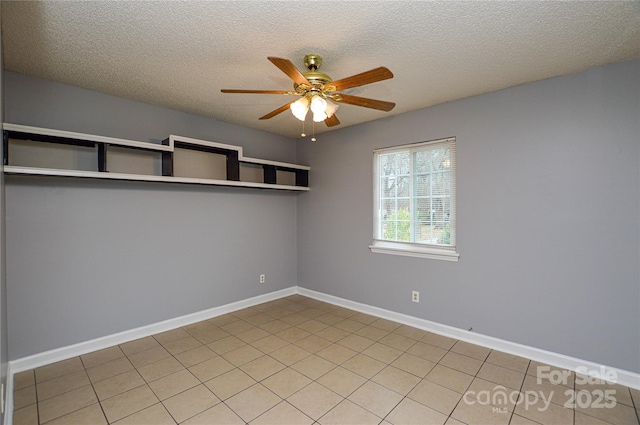 unfurnished room featuring a textured ceiling, baseboards, and ceiling fan