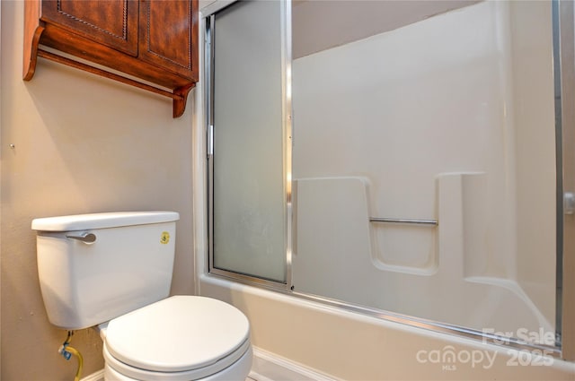 bathroom with toilet and enclosed tub / shower combo