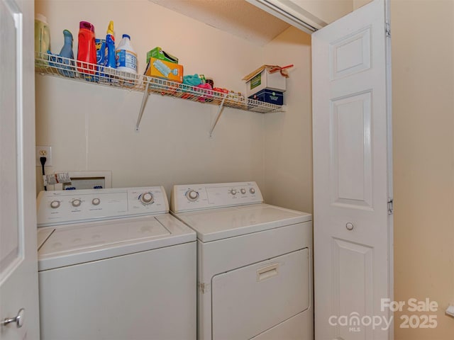 washroom featuring laundry area and washing machine and clothes dryer