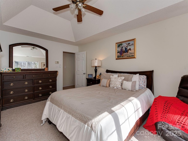 carpeted bedroom featuring lofted ceiling and a ceiling fan