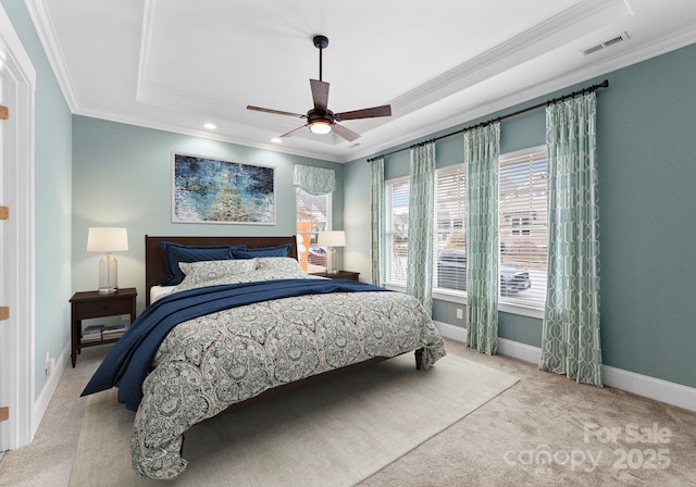 bedroom with a tray ceiling, baseboards, carpet, and ornamental molding