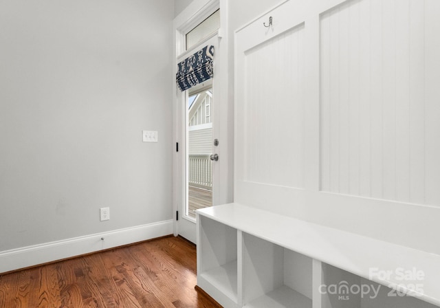 mudroom with dark wood-style floors and baseboards