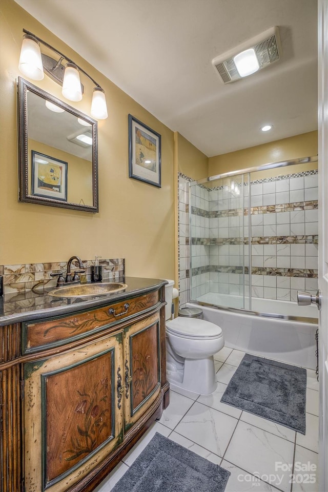 bathroom featuring vanity, visible vents, combined bath / shower with glass door, toilet, and marble finish floor