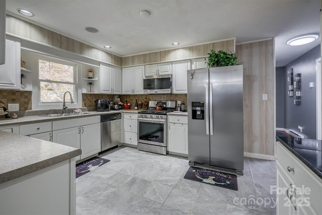 kitchen featuring open shelves, a sink, stainless steel appliances, white cabinets, and tasteful backsplash