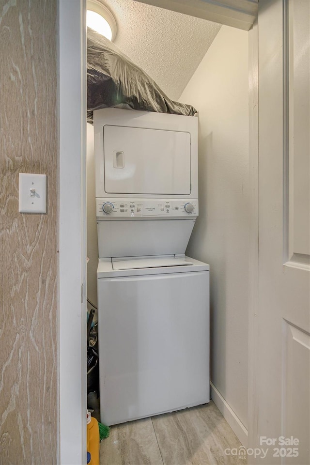 laundry area with laundry area and stacked washer and clothes dryer