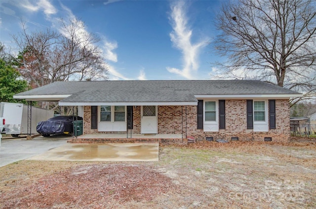 ranch-style home featuring crawl space, an attached carport, brick siding, and concrete driveway