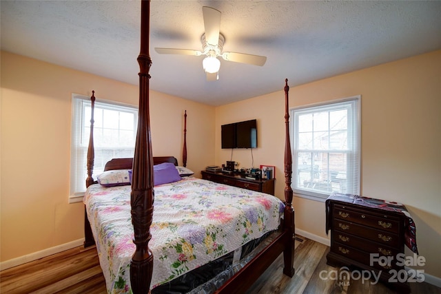 bedroom with wood finished floors, baseboards, and ceiling fan