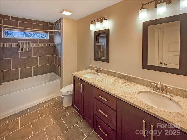 full bathroom with tile patterned flooring, double vanity, toilet, and a sink