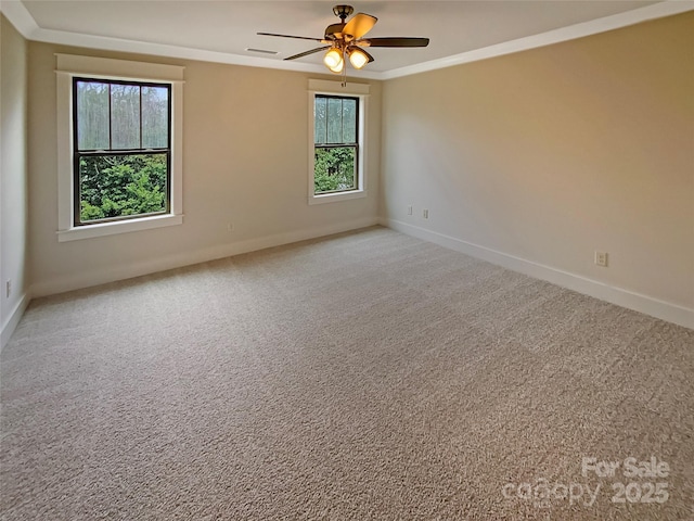 unfurnished room featuring light carpet, plenty of natural light, and crown molding