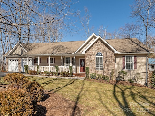 ranch-style home featuring aphalt driveway, a front yard, covered porch, stone siding, and an attached garage