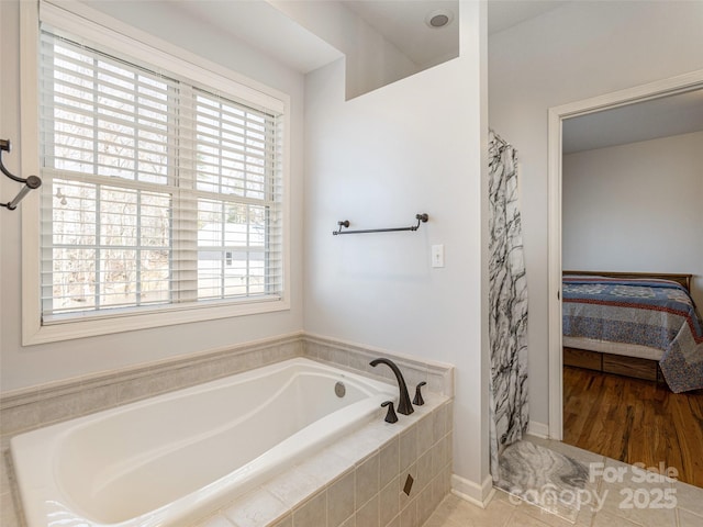 full bath with tile patterned floors, a shower with curtain, a garden tub, and ensuite bath