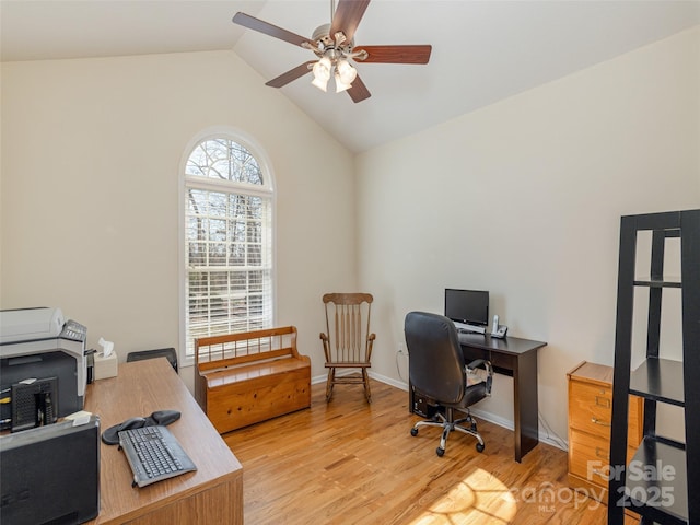 office area featuring light wood-style flooring, baseboards, a ceiling fan, and vaulted ceiling