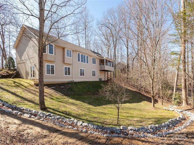 view of side of home with a yard