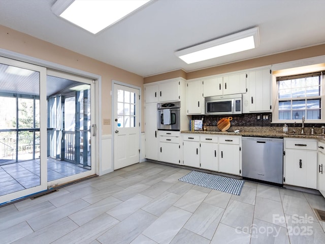 kitchen featuring white cabinetry, visible vents, appliances with stainless steel finishes, and a sink