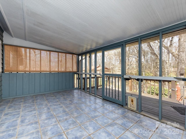 unfurnished sunroom featuring vaulted ceiling