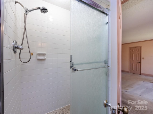 bathroom with a shower stall and crown molding