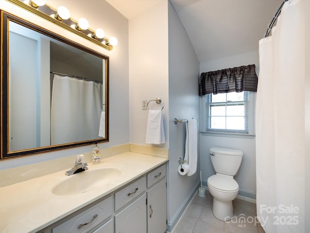 bathroom with vanity, tile patterned floors, toilet, and baseboards