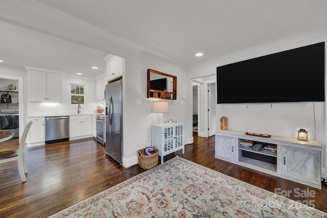 living room featuring recessed lighting, baseboards, washer / clothes dryer, and dark wood-style flooring