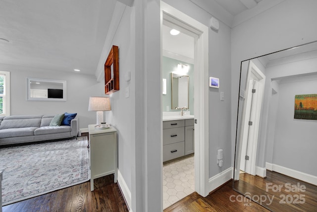 hall with dark wood finished floors and baseboards