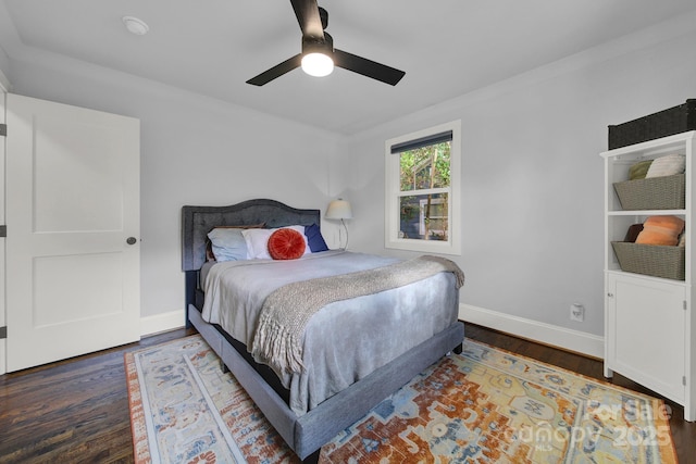 bedroom featuring ceiling fan, baseboards, and wood finished floors