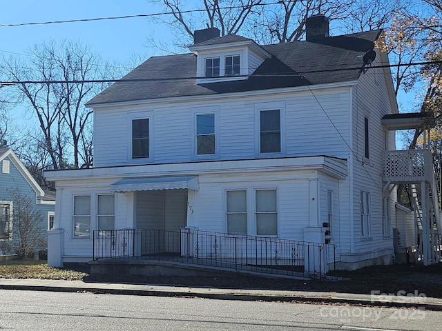 view of front facade with a chimney